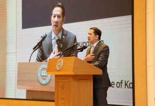 A man standing at a podium is giving a speech.